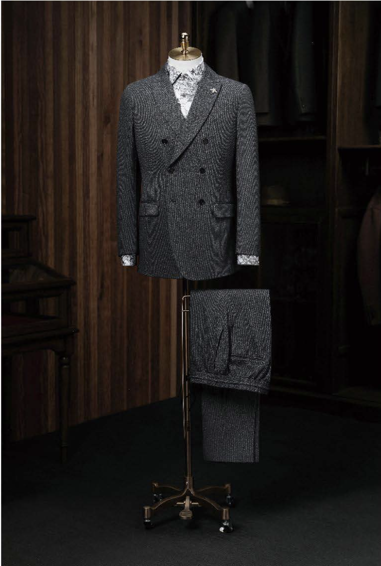 A dark grey textured double-breasted casual jacket displayed on a mannequin with matching trousers, featuring a slim fit, double vents, and front pockets.