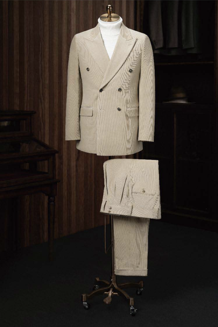 A light beige corduroy double-breasted jacket and trousers displayed on a mannequin, featuring a slim fit and double-breasted fastening with front pockets.