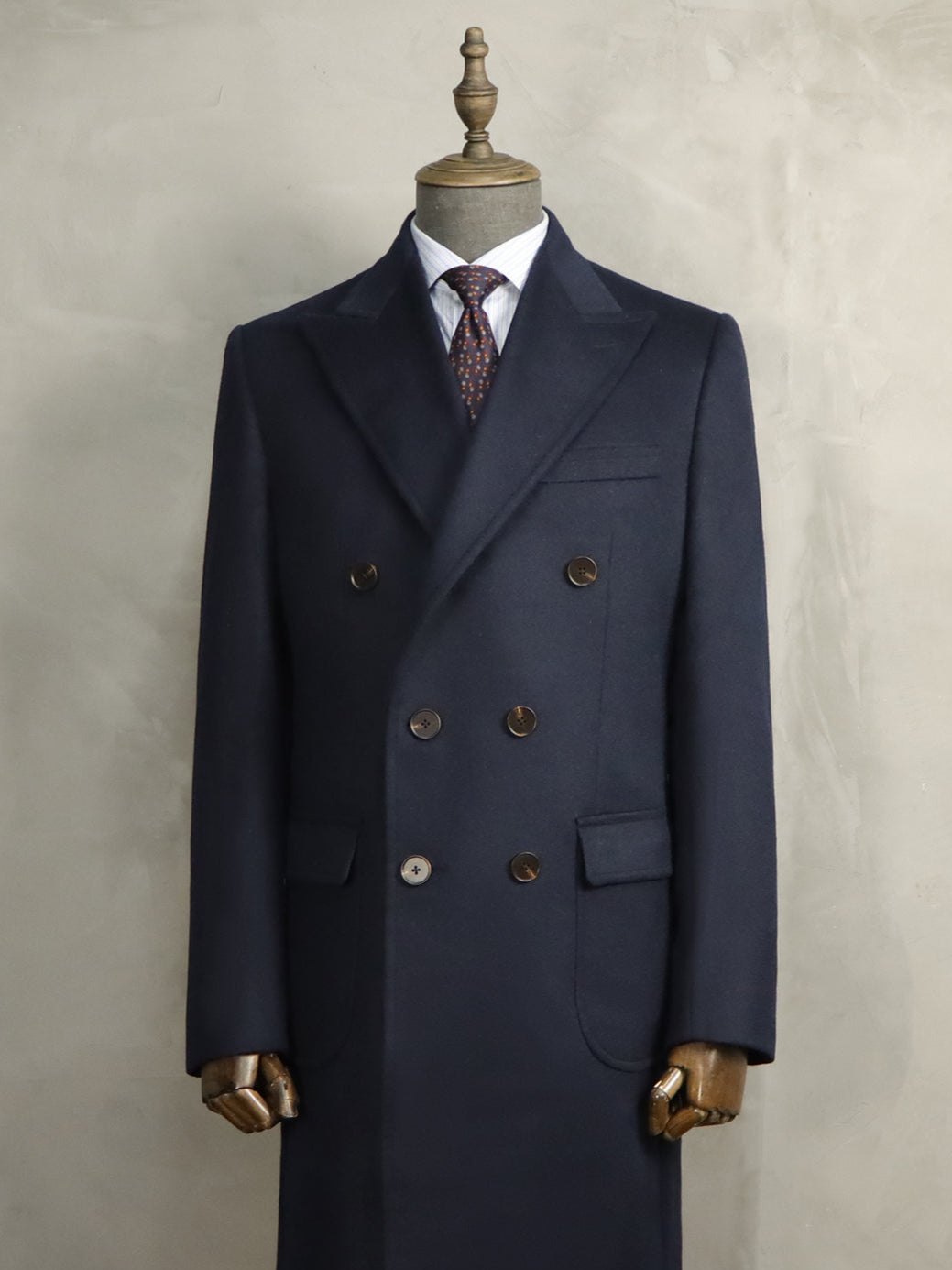 Luxurious navy cashmere double-breasted bespoke overcoat handcrafted by A Hand Tailored Suit, featuring premium cashmere fabric, traditional tailoring techniques, and personalized fit for ultimate autumn and winter elegance