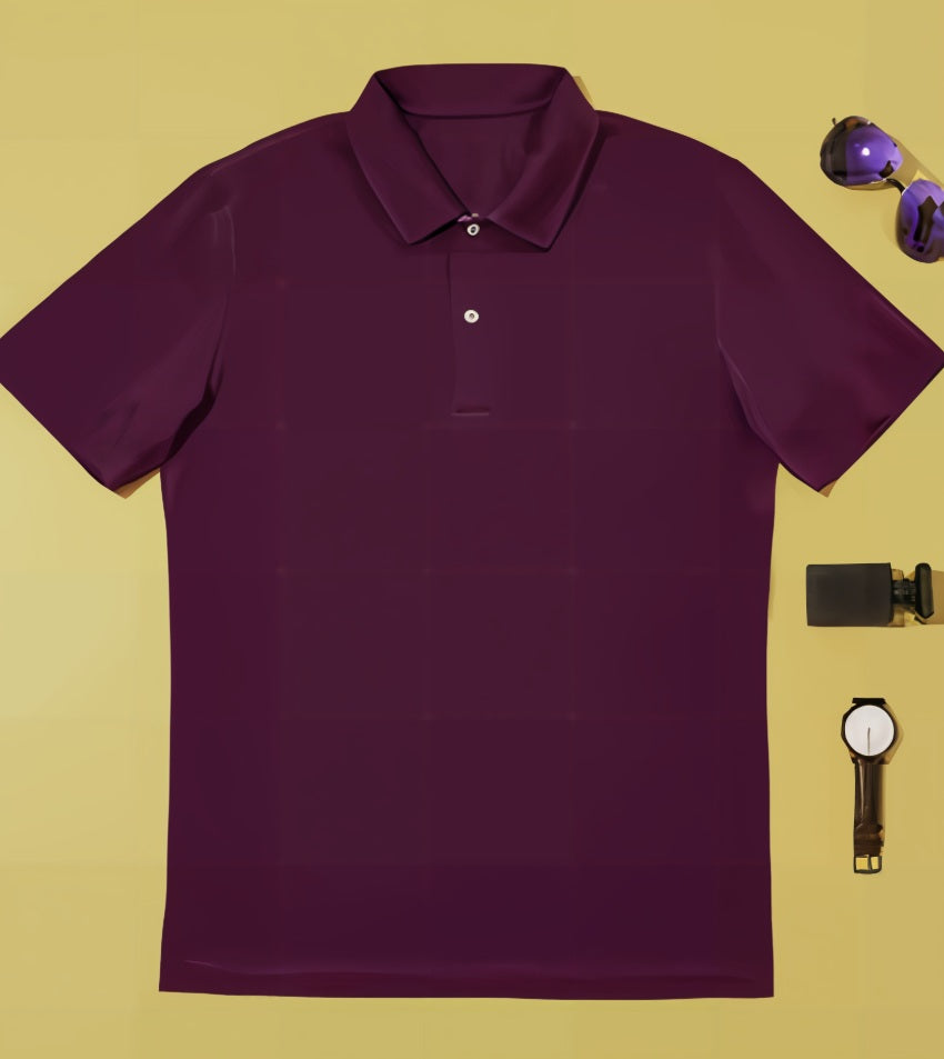 Cerise polo shirt on a yellow background with sunglasses and a watch.
