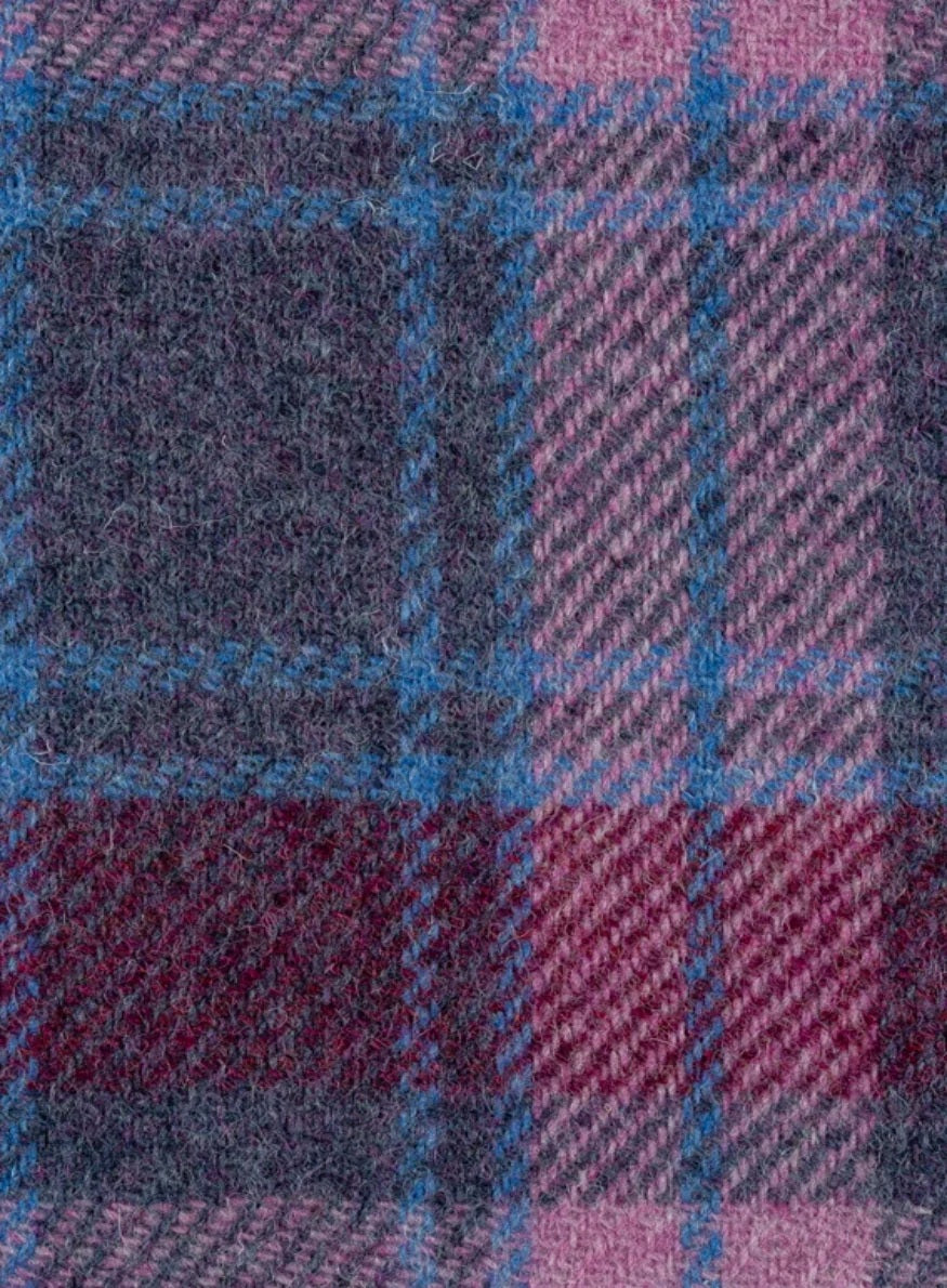Close-up of a fabric with a plaid pattern in purple, blue, and red.