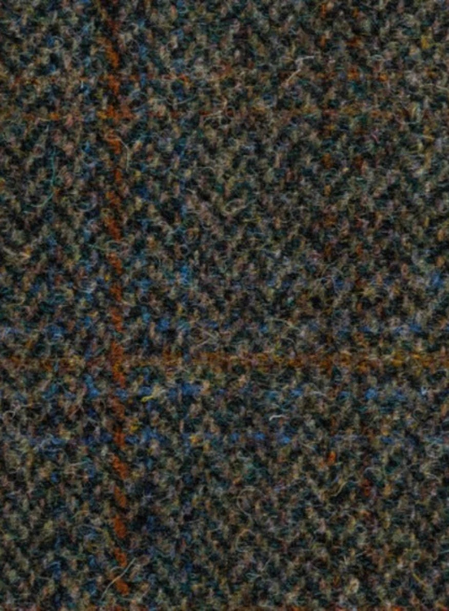 Close-up of a textured fabric with a herringbone pattern in brown, blue, and black.