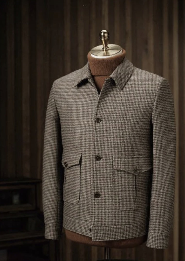 Houndstooth pattern jacket on a mannequin against a dark background