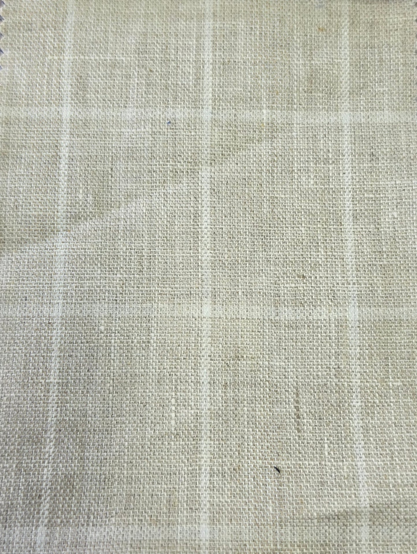 A close-up of a light beige woven fabric with a subtle white windowpane plaid pattern.