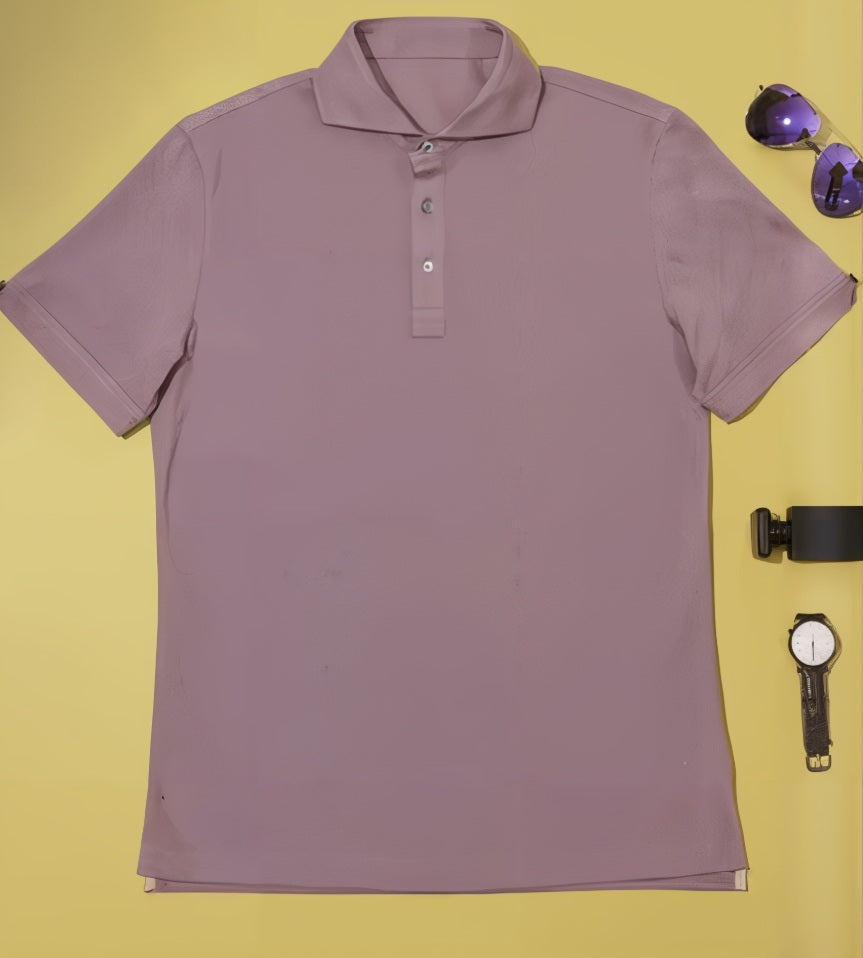 Lavender polo shirt on a yellow background with sunglasses and a watch.