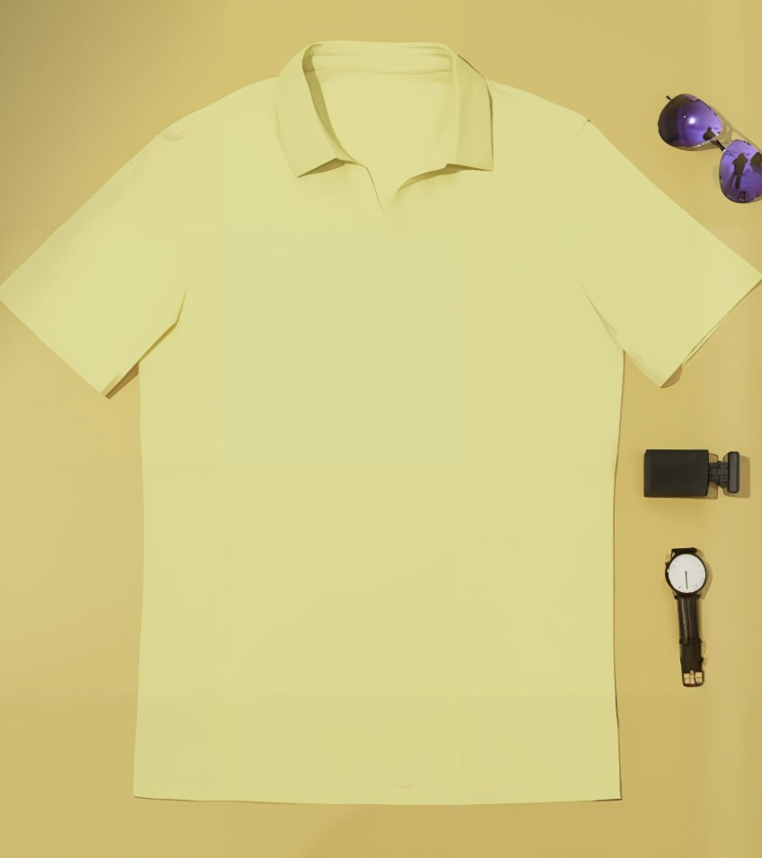 Yellow polo shirt with sunglasses and watch on a beige background