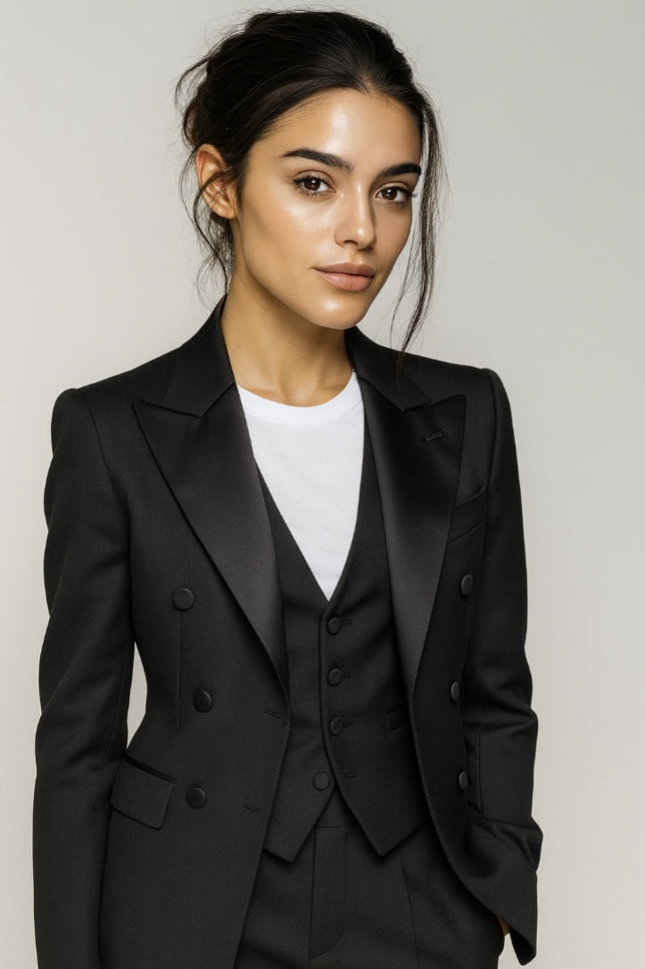 Ladies black suit with a white shirt against a plain background