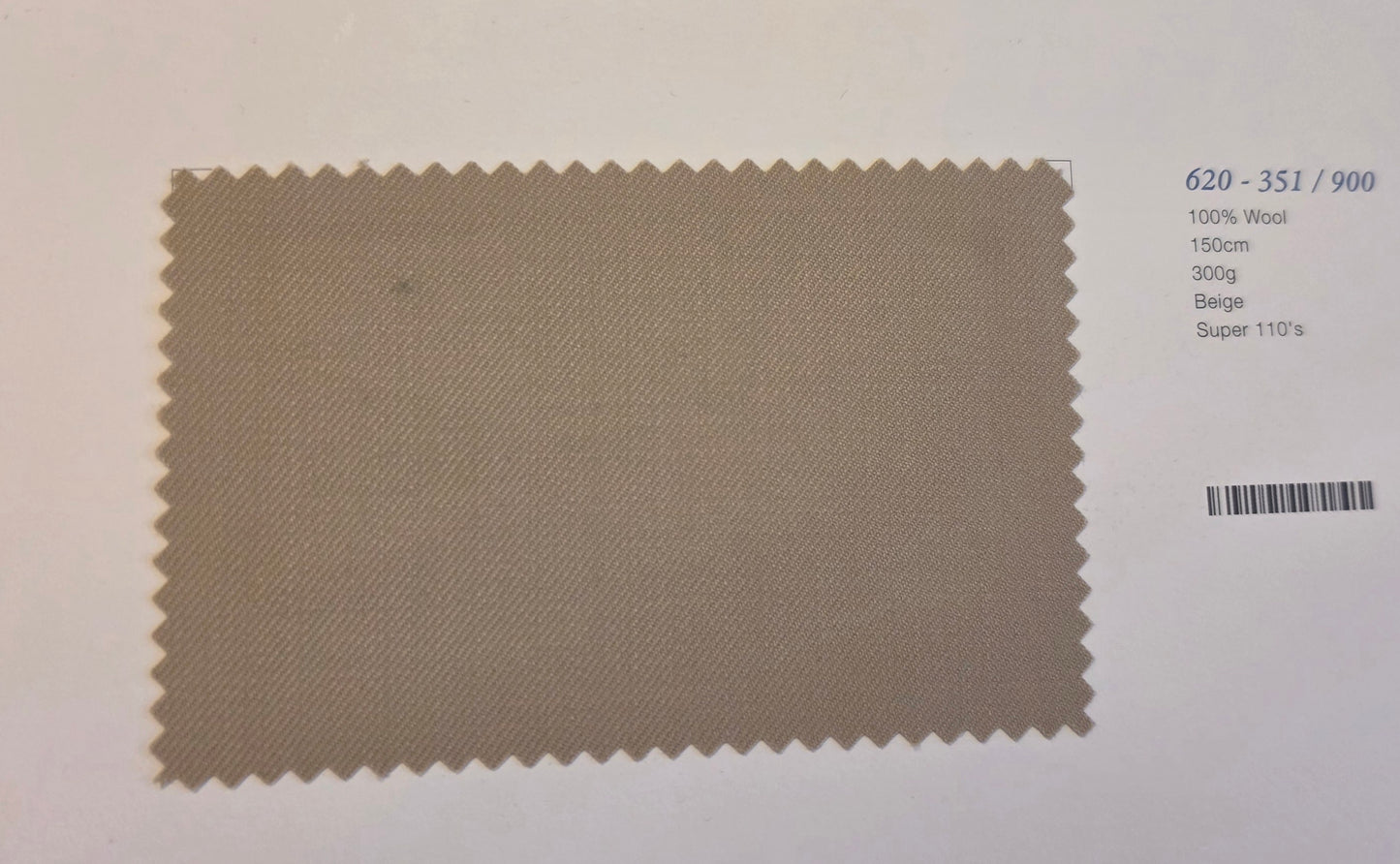A beige woven fabric swatch with serrated edges on a white background, showing product details printed on the right side.