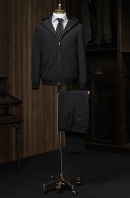 A black casual hooded zip jacket displayed on a mannequin with trousers, showcasing a slim fit and front zip detail