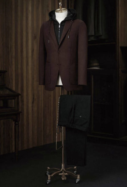 A burgundy check tweed jacket displayed on a mannequin with dark brown cord trousers, featuring a high shirt collar, front waistband, and cuffed sleeves.