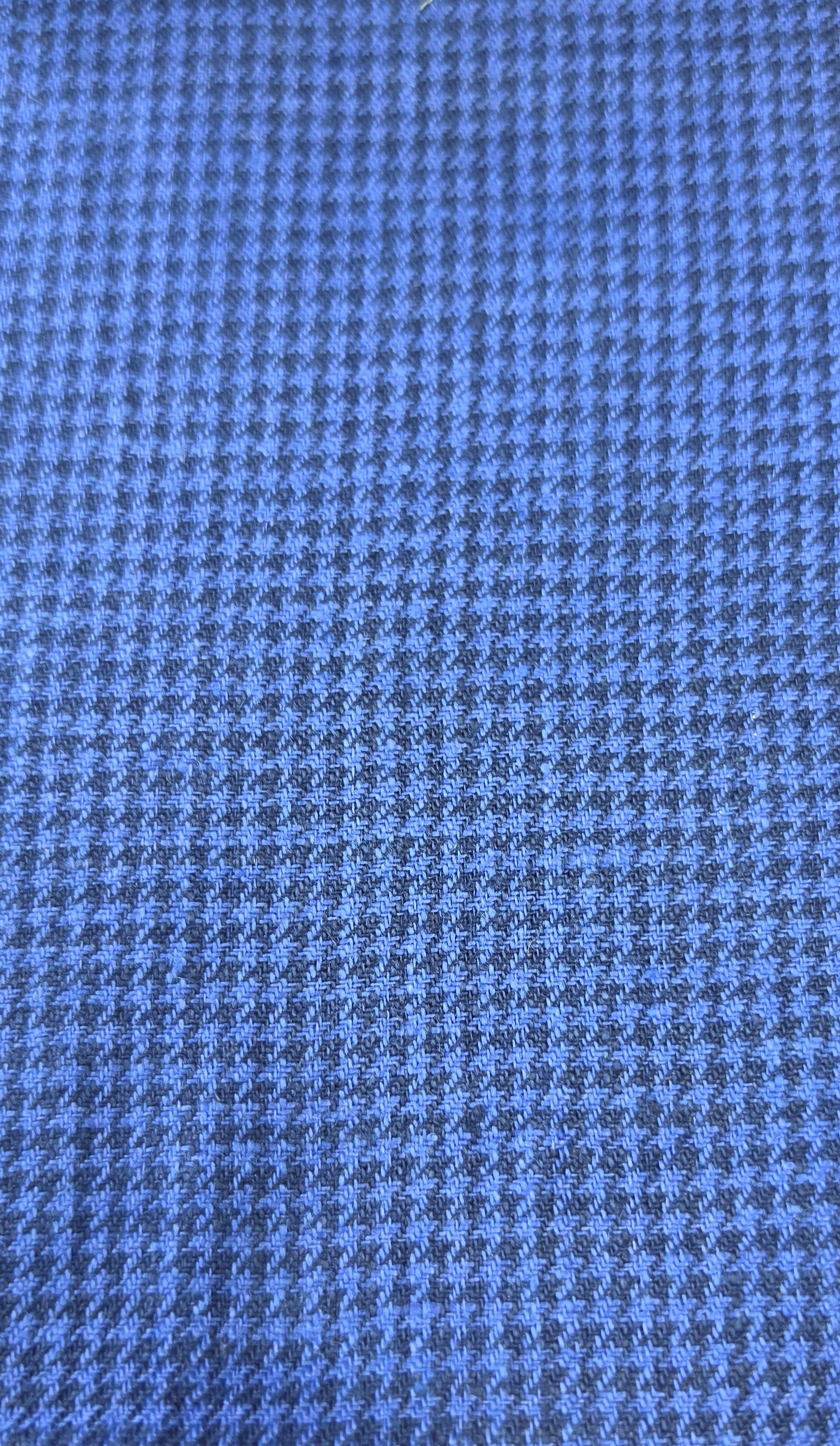 A close-up of a blue and gray houndstooth fabric pattern.
