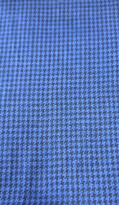 A close-up of a blue and gray houndstooth fabric pattern.