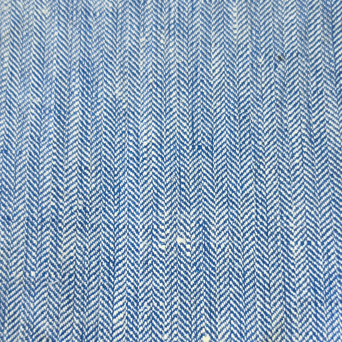 A close-up of a blue and white herringbone woven fabric texture.