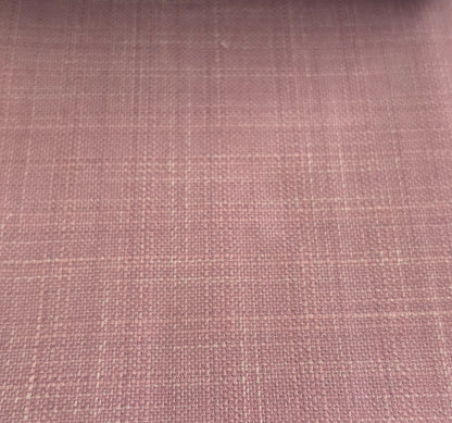 A close-up of a dusty rose pink woven fabric with a subtle grid pattern.