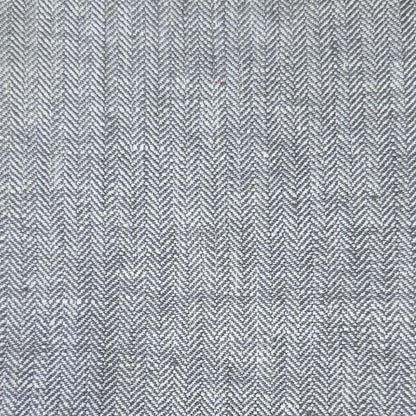 A close-up of a gray and white herringbone woven fabric texture.