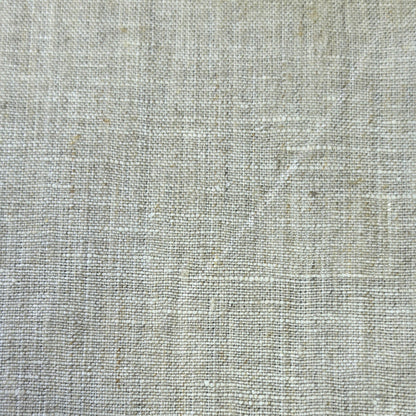 A close-up of a light beige linen fabric texture with a natural woven pattern.