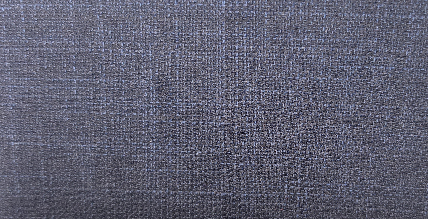 A close-up of a textured fabric with a subtle blue and gray plaid pattern.
