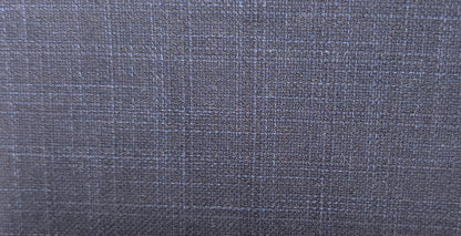 A close-up of a textured fabric with a subtle blue and gray plaid pattern.