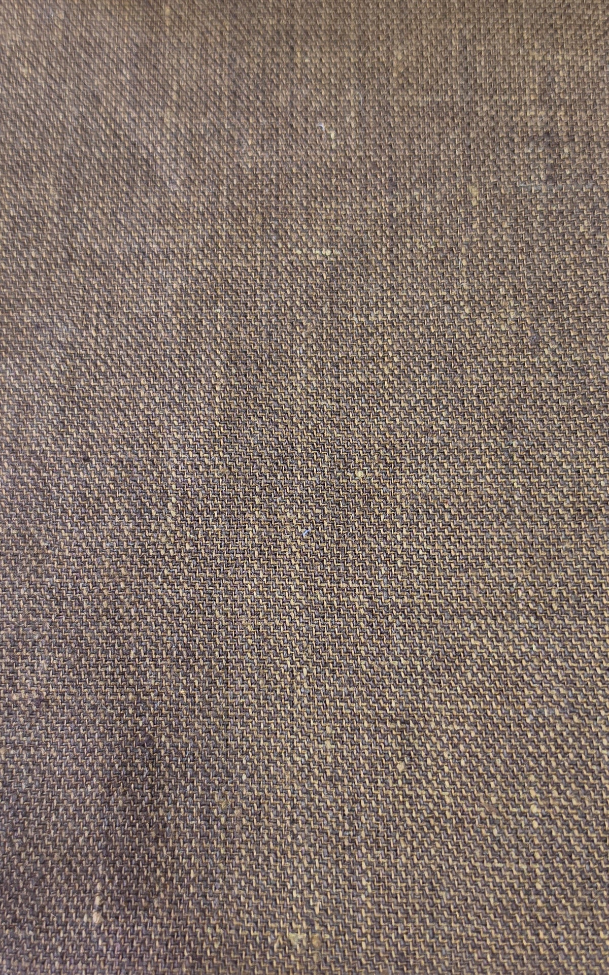 A close-up of a woven fabric texture in a medium brown color, showing the detailed weave pattern.