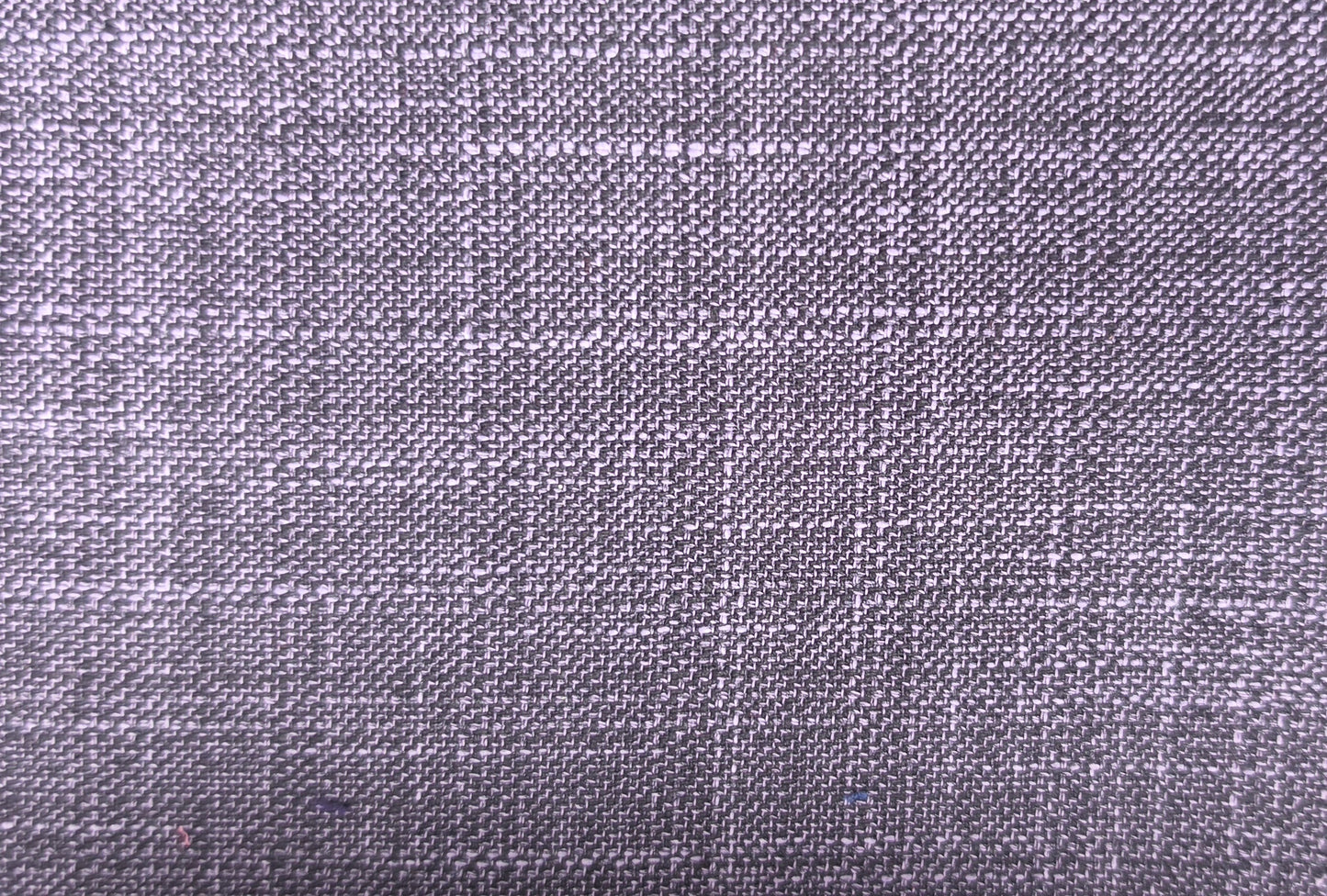A close-up of a woven fabric texture in a muted lavender-gray color, showing the detailed weave pattern.