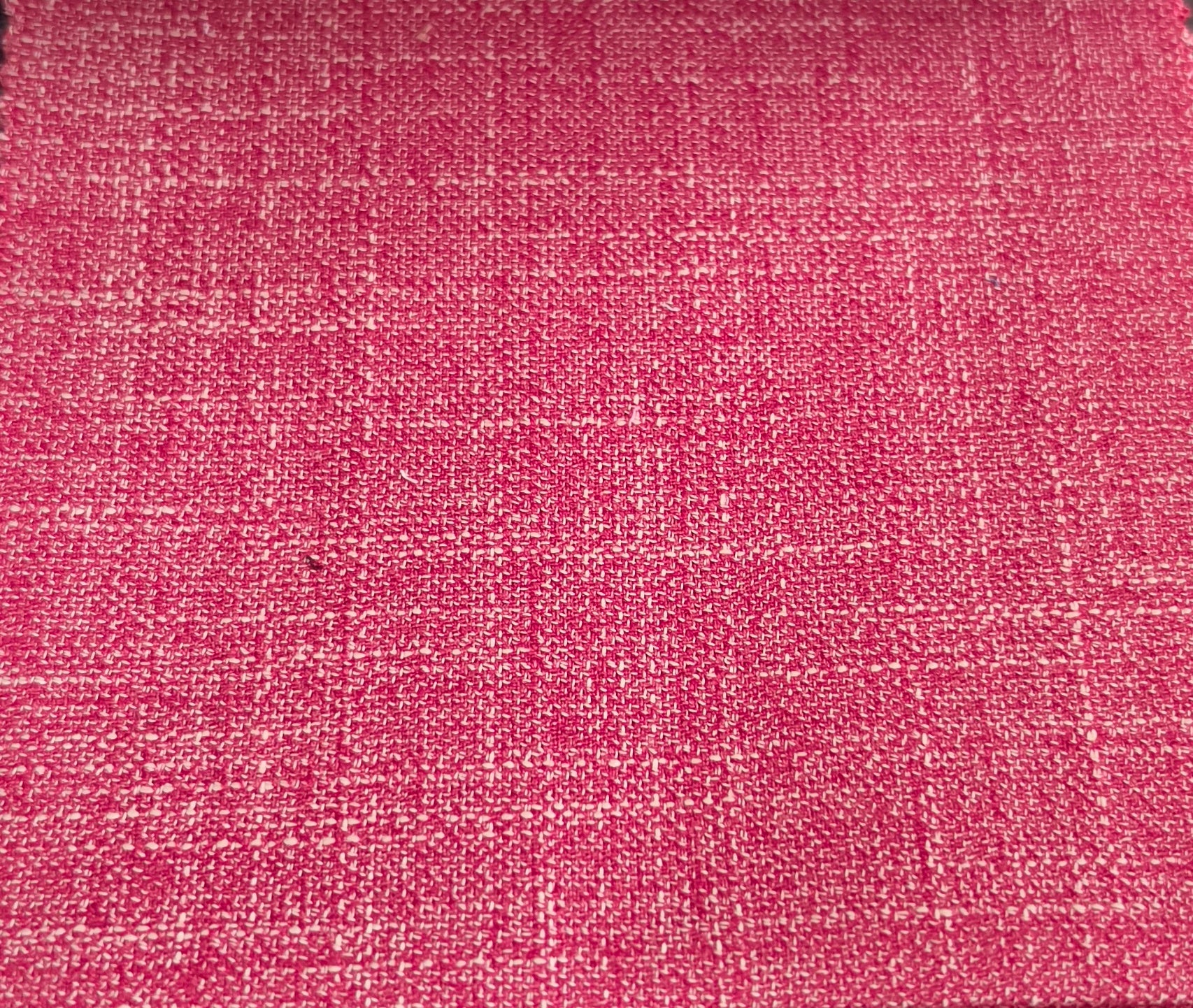 A close-up of a woven fabric texture in a vibrant pink color with subtle lighter pink and beige threads creating a subtle grid pattern.