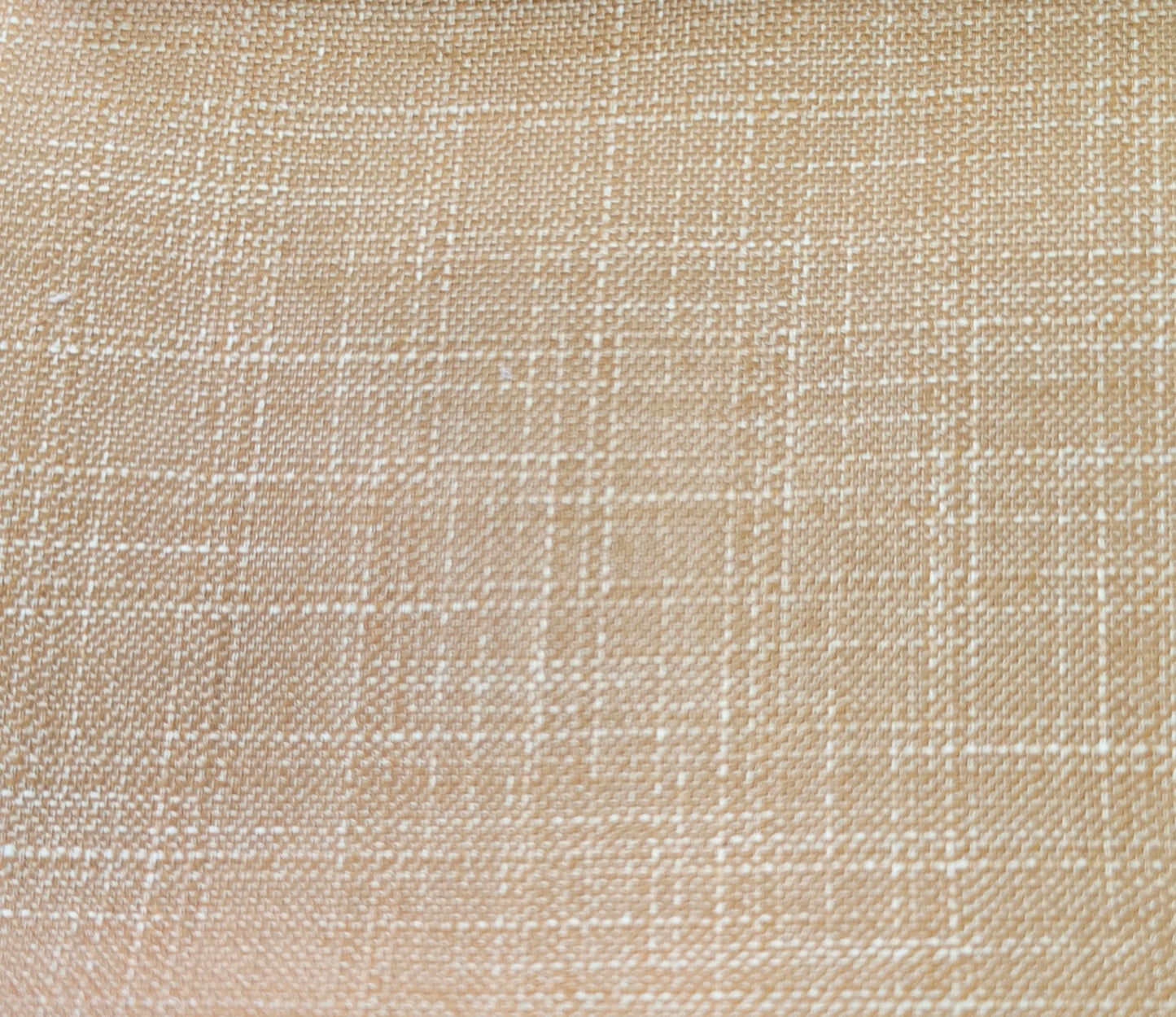 A close-up of a woven fabric texture in a warm beige color with a subtle white grid pattern.