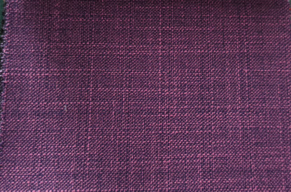 A close-up of a woven fabric with a subtle windowpane plaid pattern in deep purple and magenta tones.