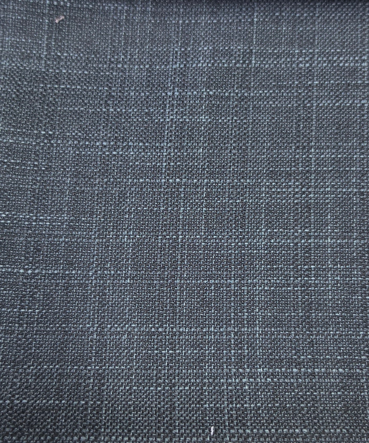 A close-up of dark charcoal gray woven fabric with a subtle blue-gray plaid pattern.