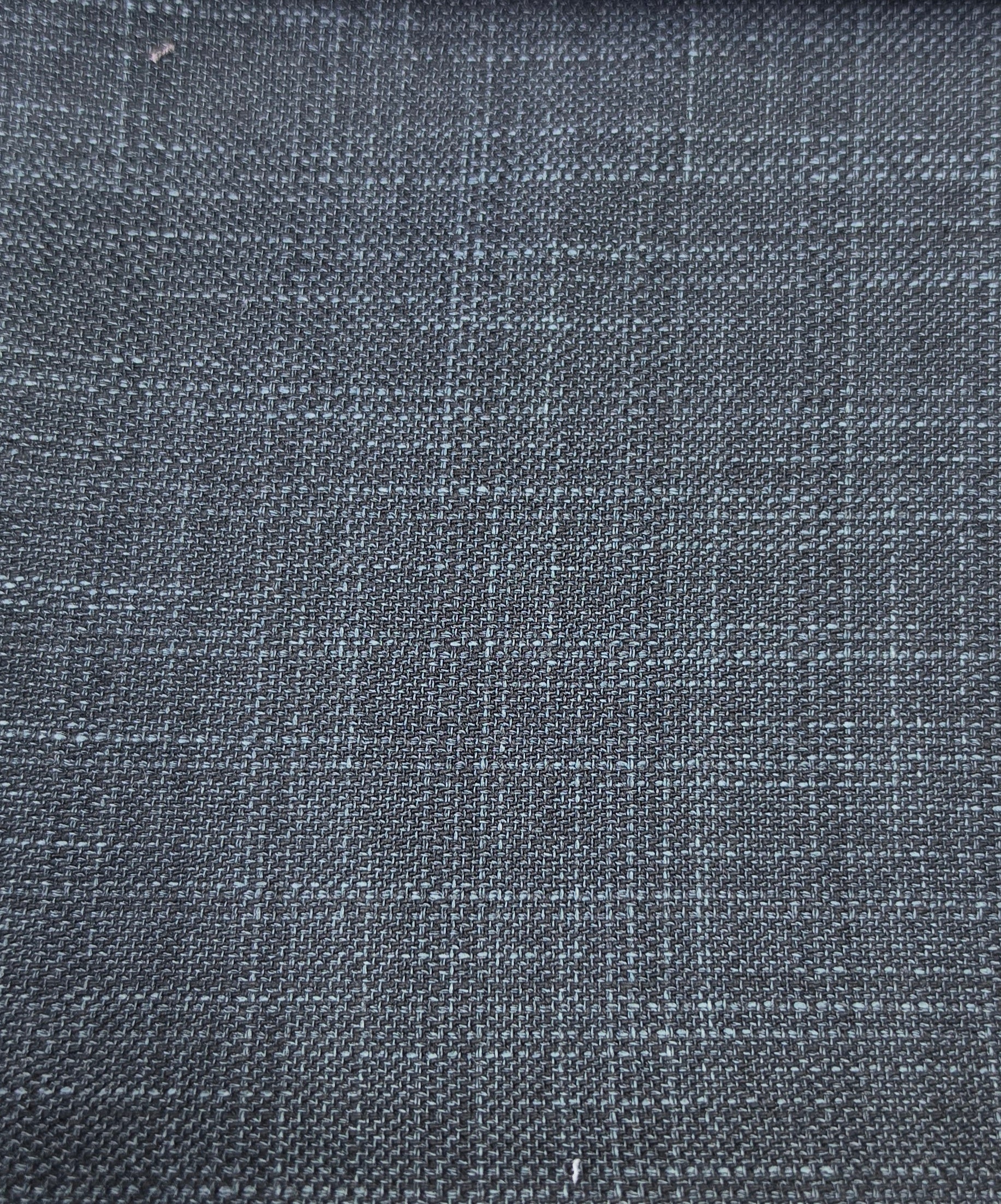 A close-up of dark charcoal gray woven fabric with a subtle blue-gray plaid pattern.