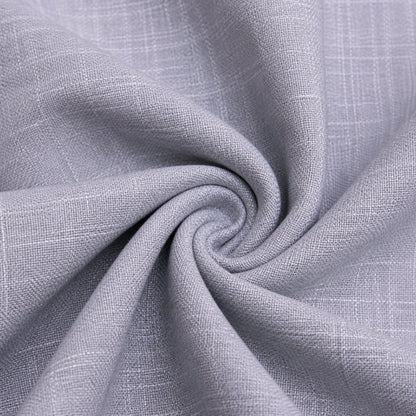 A close-up of light gray woven fabric with a subtle plaid texture, arranged in a spiral drape to show the material's texture and flexibility.