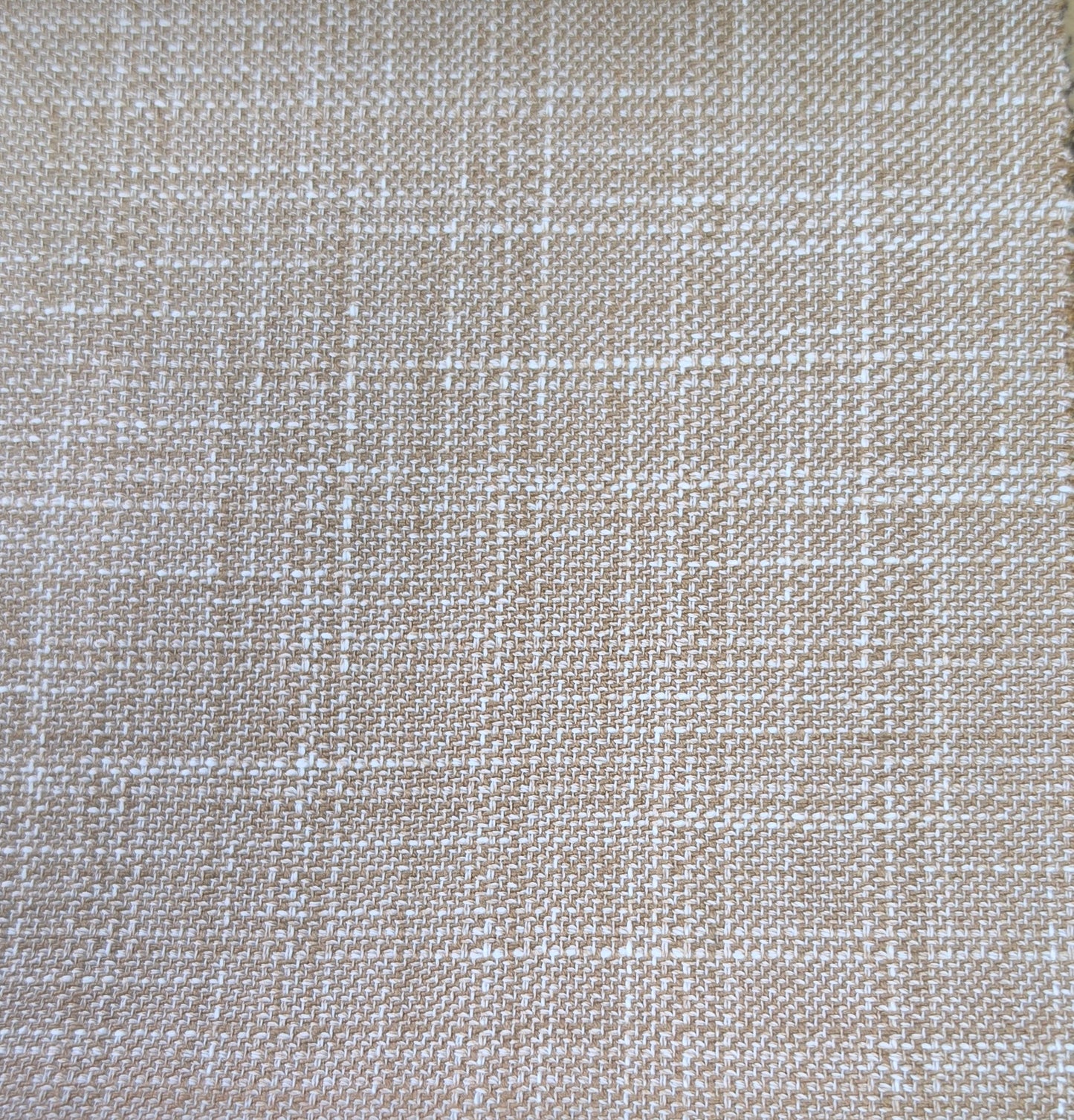 A close-up of woven fabric with a subtle plaid pattern in beige and off-white.