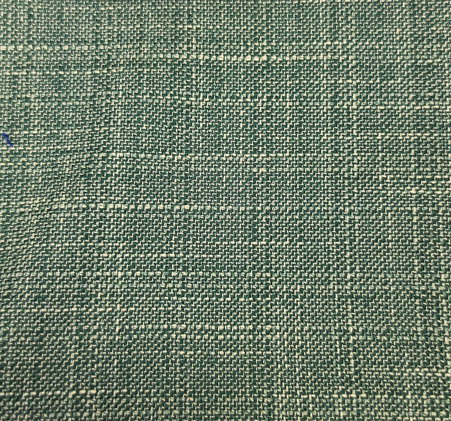 A close-up of woven fabric with a textured, basketweave-like pattern in muted green and beige tones.