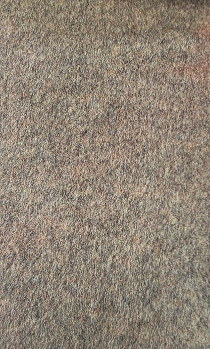 A close-up texture shot of a mottled wool fabric with a blend of gray, brown, and beige fibers.