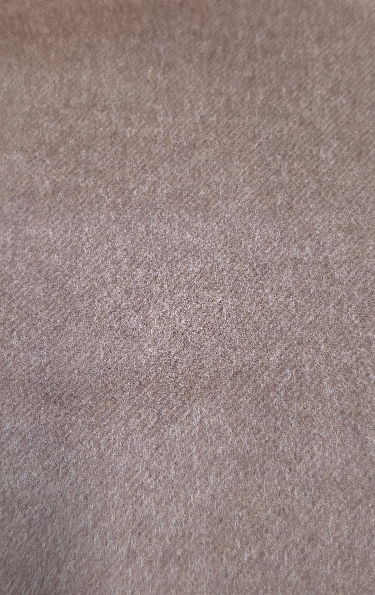 A close-up texture shot of a soft, heathered fabric in a dusty taupe or light brown color.