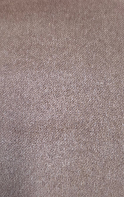 A close-up texture shot of a soft, heathered fabric in a dusty taupe or light brown color.