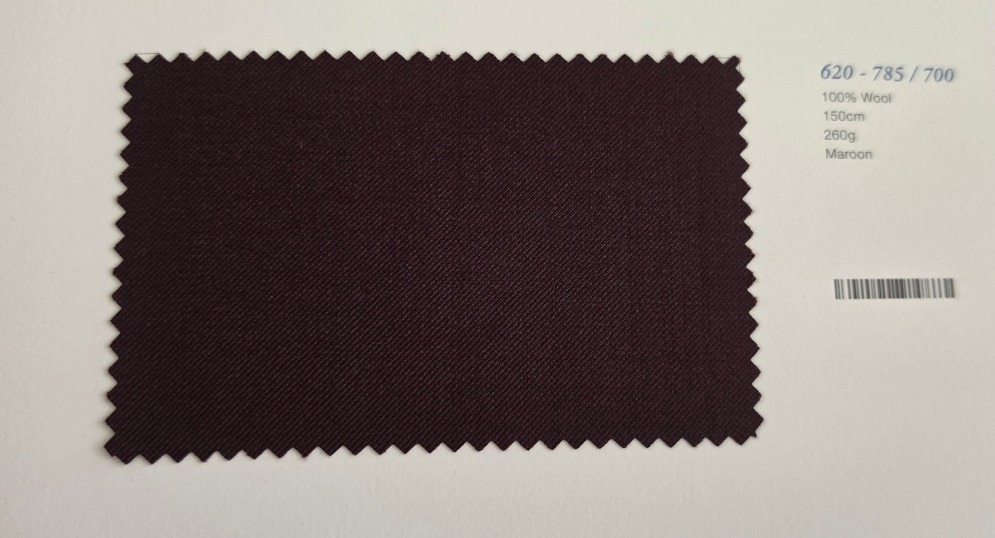 A dark Maroon fabric swatch with serrated edges, displayed on a white background next to printed fabric specifications.