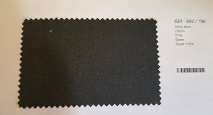 A dark charcoal gray fabric swatch with serrated edges, displayed on a white card next to printed specifications.