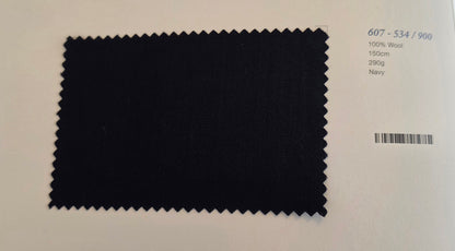 A dark navy fabric swatch with serrated edges on a white background, next to printed text showing color code 607-534/900, 100% Wool, 150m, 290g, and Navy.