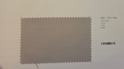 A fabric color swatch card showing a beige woven wool sample with serrated edges, alongside printed text including '620 - 776 / 700', '100% Wool', '150m', '270g', and 'Beige'.