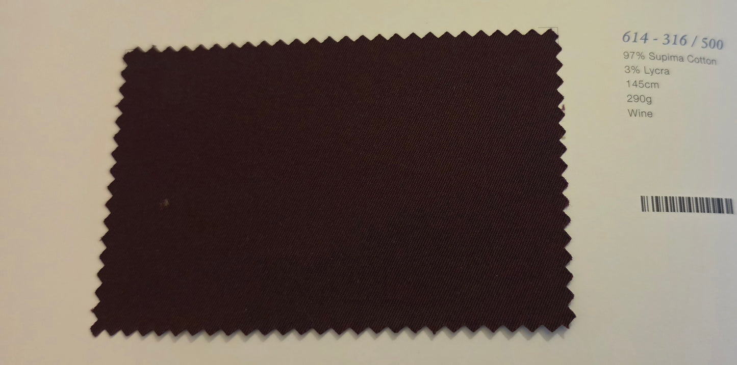 A fabric color swatch card showing a dark wine-colored material sample with serrated edges, alongside printed color code text and a barcode on a white background.