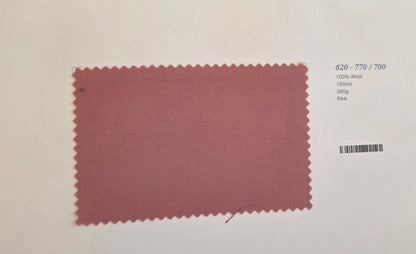 A fabric color swatch card showing a dusty rose pink woven material with a serrated edge, labeled with text on the right side including '620 - 770 / 700', '100% Wool', '150m', '280g', and 'Pink'.