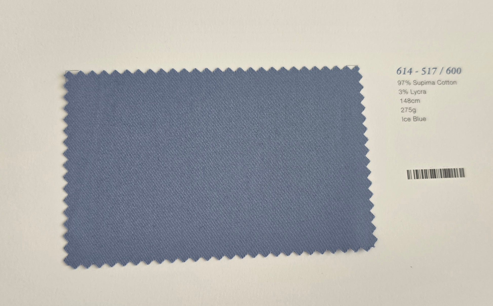 A fabric color swatch card showing a textured light blue material with serrated edges, labeled with code 614-S17/600 and color name 604 Blue on a white background.