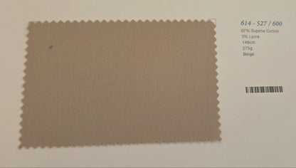 A fabric color swatch card showing a textured taupe-beige swatch with a serrated edge, printed on a white card with a barcode and text below.