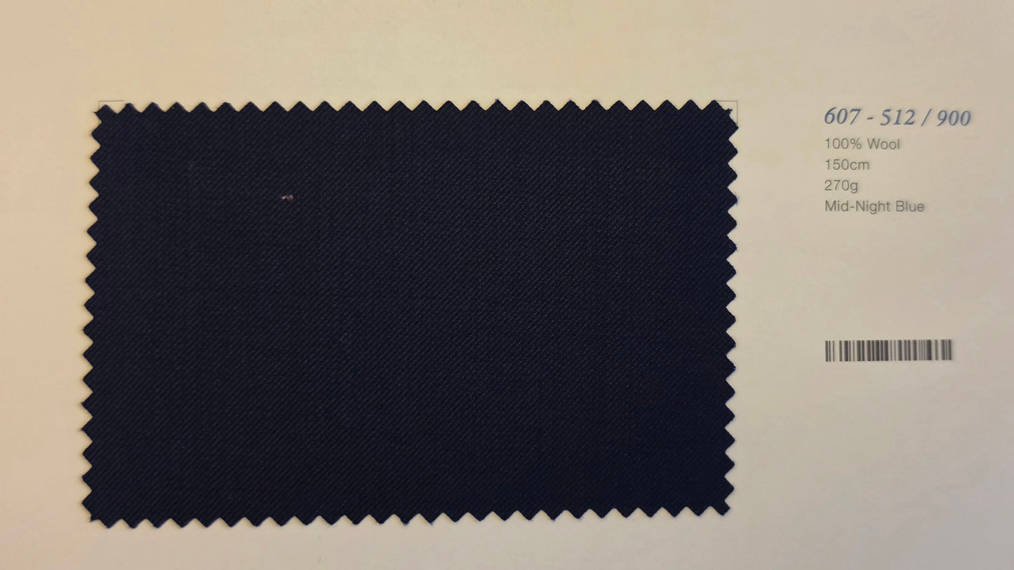 A fabric color swatch of Mid-Night Blue wool, showing a dark navy blue textured weave with zigzag-cut edges, displayed on a light beige background with product details printed on the right.