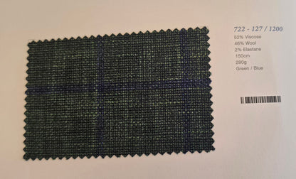 A fabric swatch card showing a dark green and blue plaid pattern, with printed specifications on the right side against a light background.