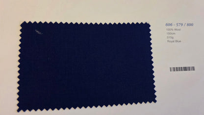 A fabric swatch card showing a dark royal blue wool material with zigzag-cut edges, alongside printed text including the code 606-579/800, 100% Wool, 150cm, 31kg, and Royal Blue.
