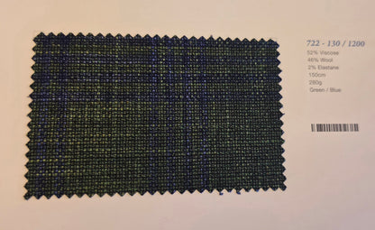 A fabric swatch card showing a textured woven material in a green and blue plaid pattern, with printed text on the right side detailing the composition and color.