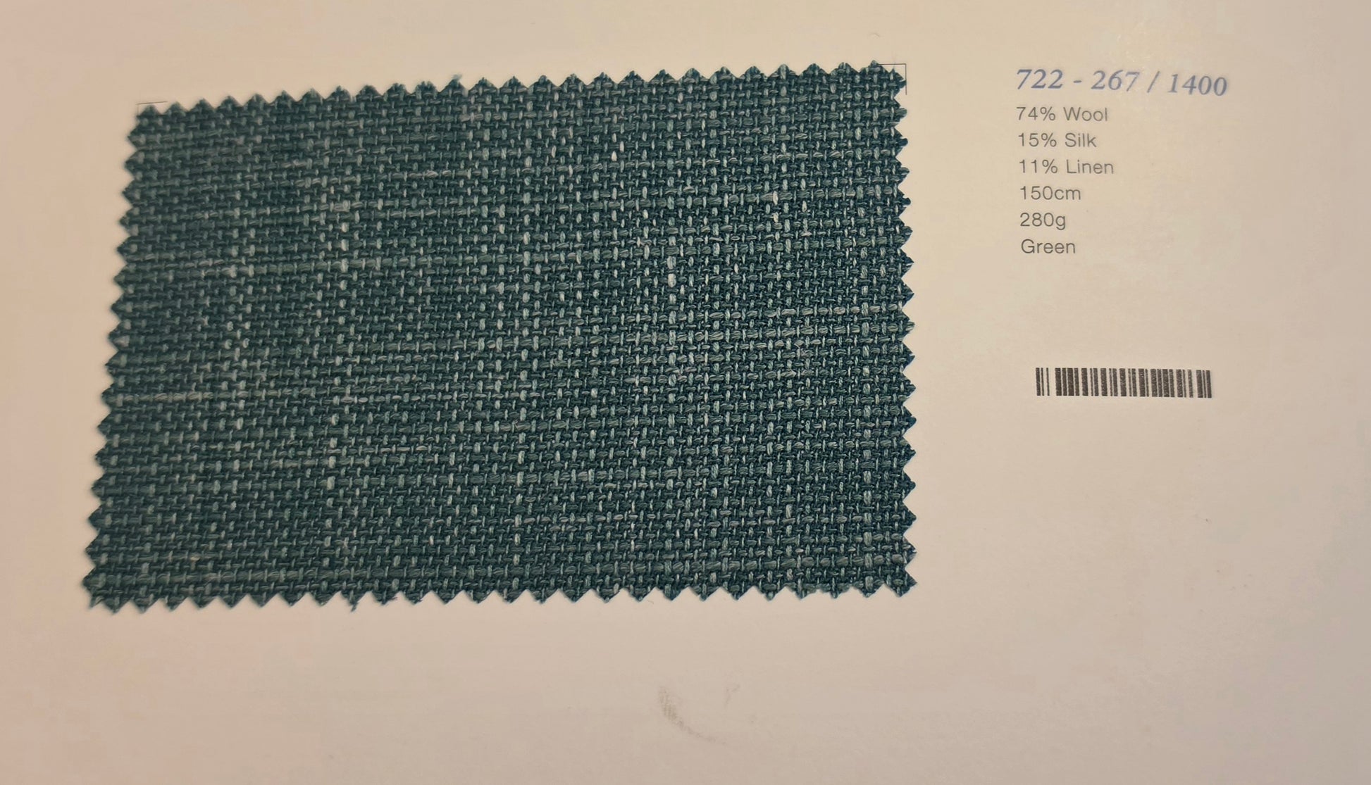 A fabric swatch card showing a woven green textile sample on a white background, with printed text on the right listing material composition and color.