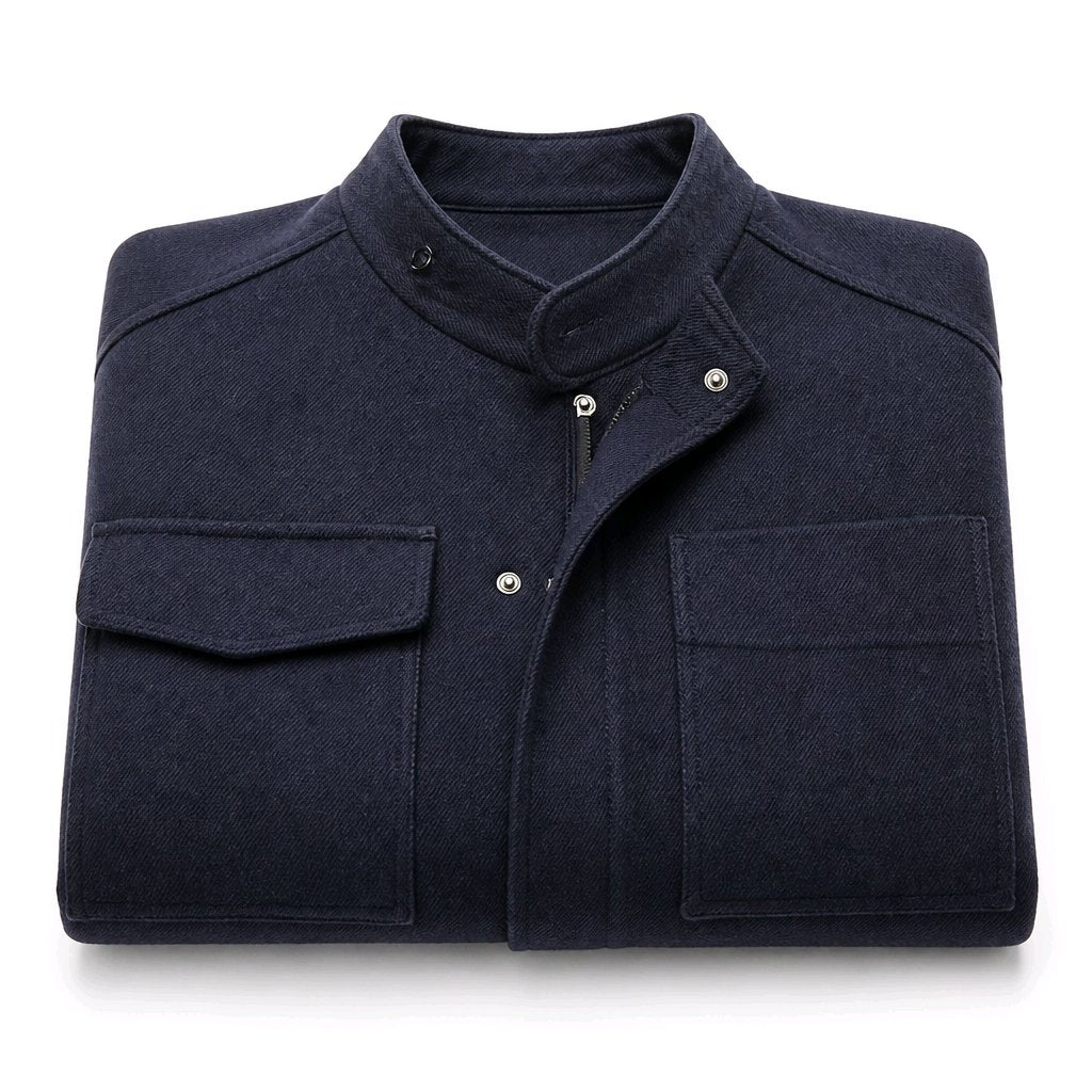 A folded dark navy blue utility jacket with a stand collar, snap-button placket, and two large front flap pockets, shown on a clean white background.