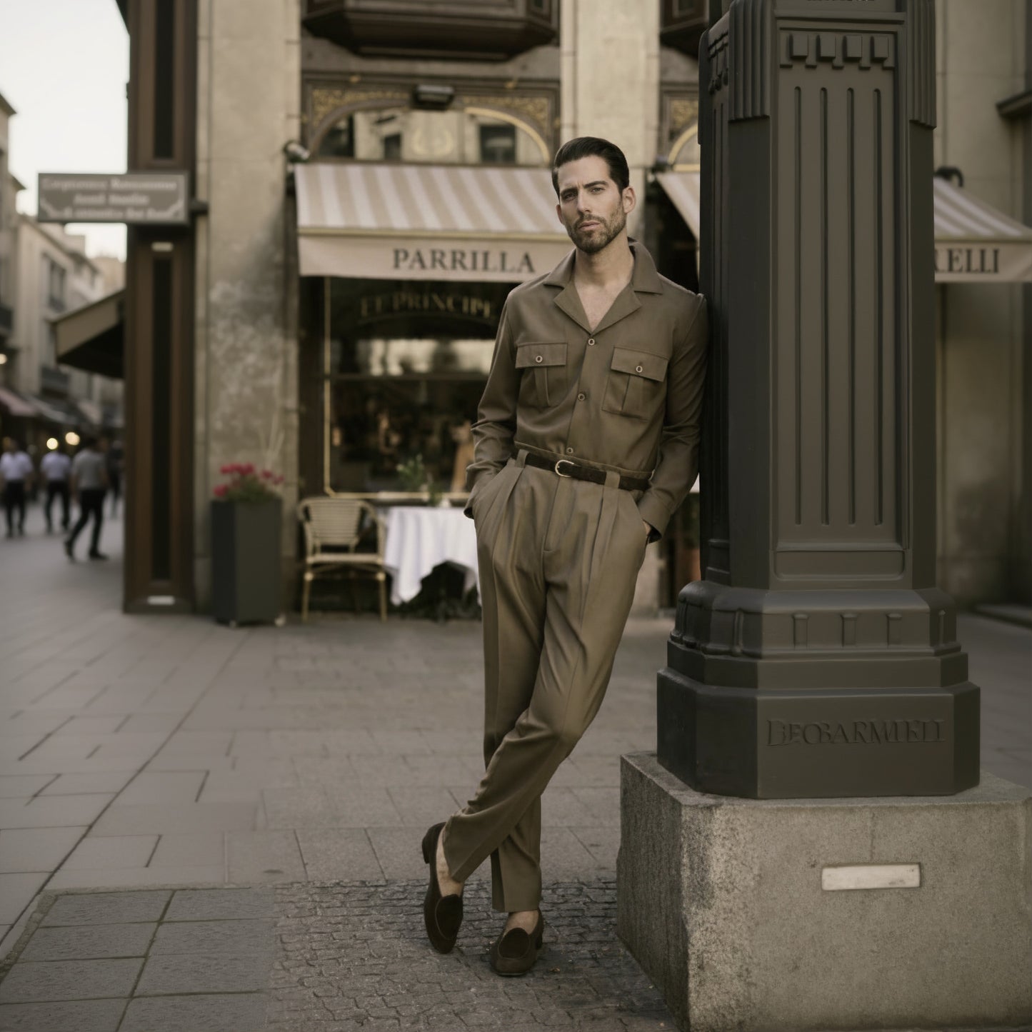 A man standing on the sidewalk wearing a brown two-piece wool stretch suit with a double-breasted jacket and trousers, featuring double pleats and front pockets.